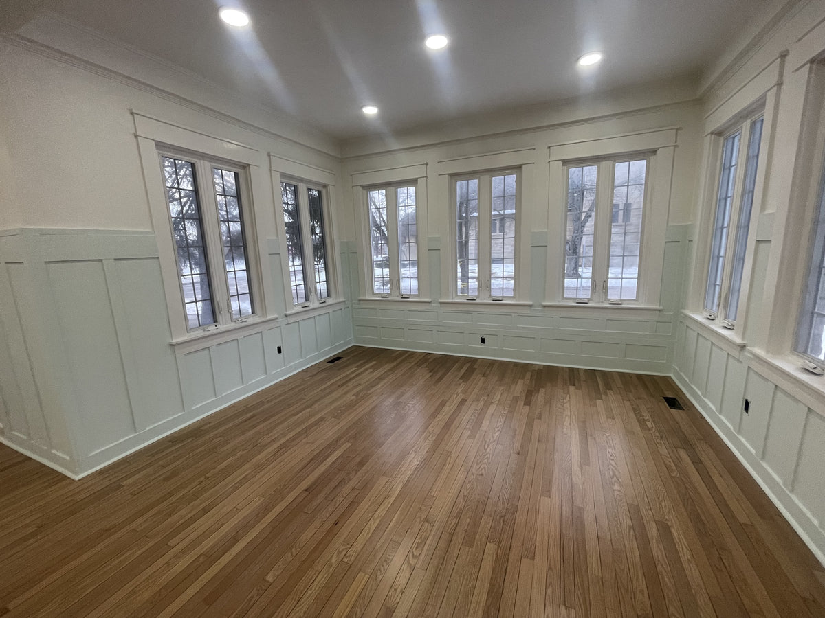 Finished sunroom with white painted wainscoting and walls by Cardinal Painting Services
